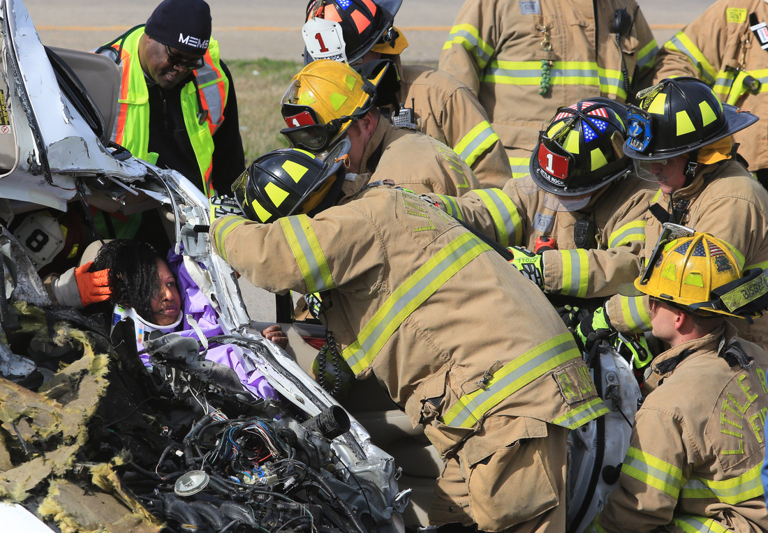 1st place in the 2014 Spot News Category: Little Rock firefighters and MEMS medical technicians work to free the female driver of a Lexus that was struck by a vehicle that was fleeing Arkansas State Police officers on the ramp from S. Chester St. to eastbound  I-630 in Little Rock Thursday. The male driver of the fleeing car fled on foot across I-630 and was caught by officers on the other side. The female was the only one injured.
