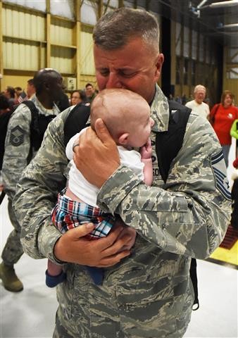 20th Fighter Wing returns home 
An Air Force senior master sergeant who just completed his 11th overseas deployment cries while holding his grandson who was born during his deployment to the Middle East. (An entry in the 2015 SNPA Photo Contest.  Photographers are not identified until after the contest.)